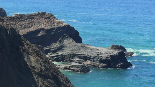 rock formation like croc Algarve Portugal coastal walk Fishermans trail seascapes and quiet beaches blue skies sunshine and shimmering Atlantic Ocean epic locations