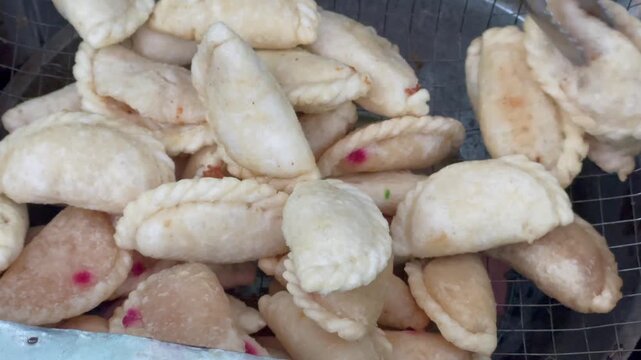 Indonesian traditional fried snack cireng isi with various fillings on a wire rack