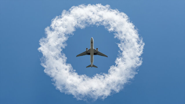 Airplane Flying Through A Circular Smoke Trail Against A Clear Blue Sky, Stunt Performance Concept