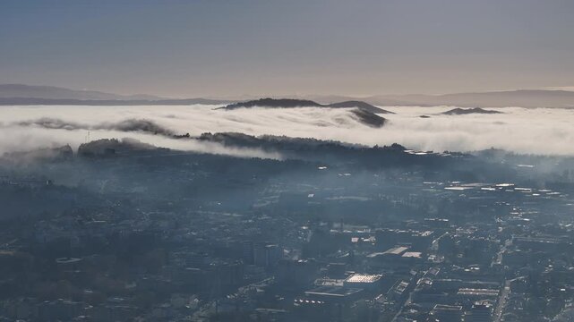 Low clouds rolling into the city in the morning light.