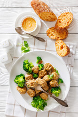 Belgian meatballs in creamy gravy with broccoli and bread