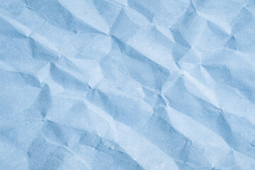 Obraz premium Soft blue crumpled paper texture with natural folds and subtle shadows. Minimal abstract background with gentle light and delicate creases. Calm pastel tone perfect for design, branding, packaging moc