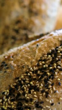 Delicious turkish simit in vibrant market Fresh bread baguettes with sesame and flax seeds on rustic rough burlap