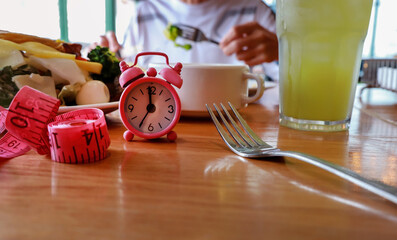 Intermittent Fasting and Meal Timing with Pink Alarm Clock for a Balanced Diet