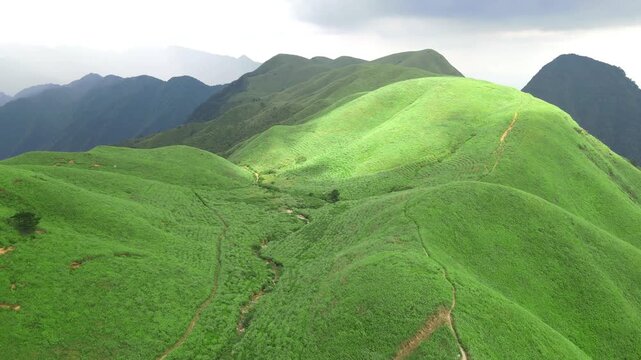 Descending drone view of green mountain ridge in Wugong Mountain