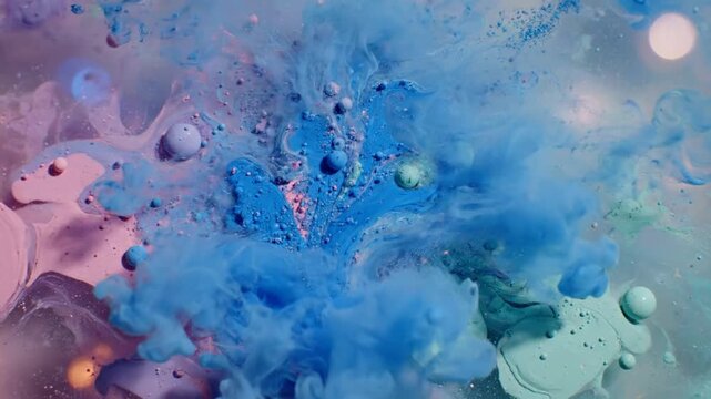 Abstract macro shot of vibrant blue, pink, and minty green colors blending in water, creating unique patterns and textures