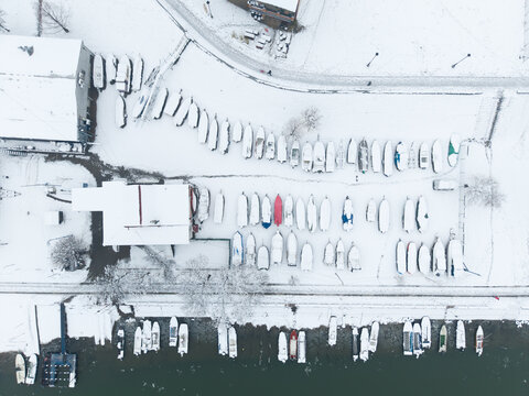 Pancevo, Serbia - January 05 2026: Tamis river in the winter. River in the winter with snow. Boats, bridge. Aerial view. Drone shot. Boats in a river.