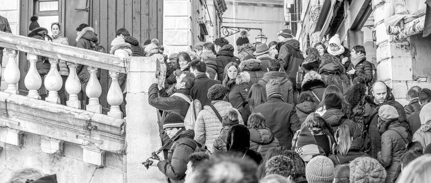 Venice, Italy - February 8, 2015: Crowd along Rialto Bridge during the carnival parade