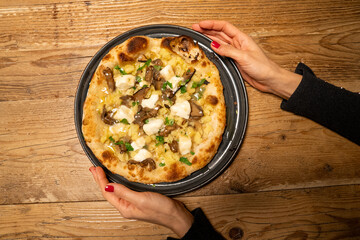 Delicious Italian pizza served on plate ready to eat with melted cheese and toppings