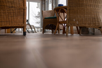 Low angle shot of a modern terrace of a mountain lodge with wicker chairs.