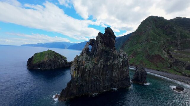 Sea Stack and Green Mountain Slopes Along Madeira Coastline, Portugal