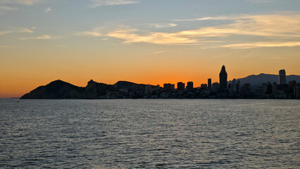 Benidorm skyline silhouettes at sunset over mediterranean sea © Chebix