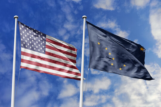 The American and Alaska state flags wave proudly against a blue sky, symbolizing northern heritage, frontier spirit, patriotic unity, vast wilderness, and the strategic bond of the Last Frontier.