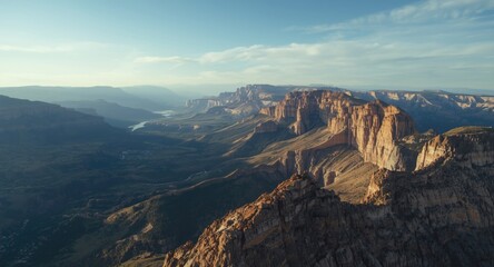 Wide aerial perspective of towering mountain ridges and cliffs