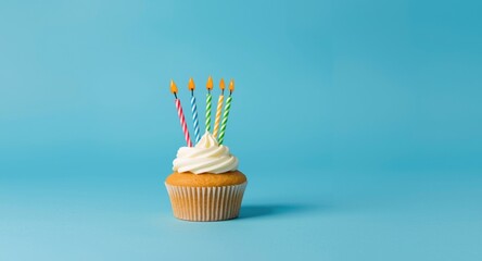 Cheerful cupcake adorned with playful candles on blue background