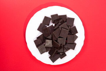 Delicious chocolate on a white plate against a colorful background