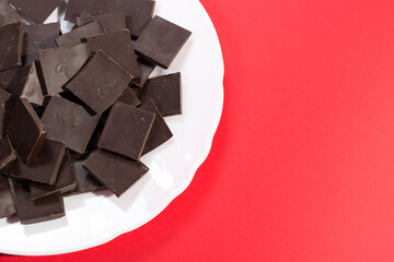 Delicious chocolate on a white plate against a colorful background