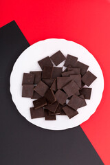 Delicious chocolate on a white plate against a colorful background