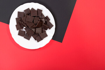 Delicious chocolate on a white plate against a colorful background
