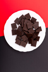 Delicious chocolate on a white plate against a colorful background