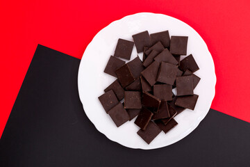 Delicious chocolate on a white plate against a colorful background