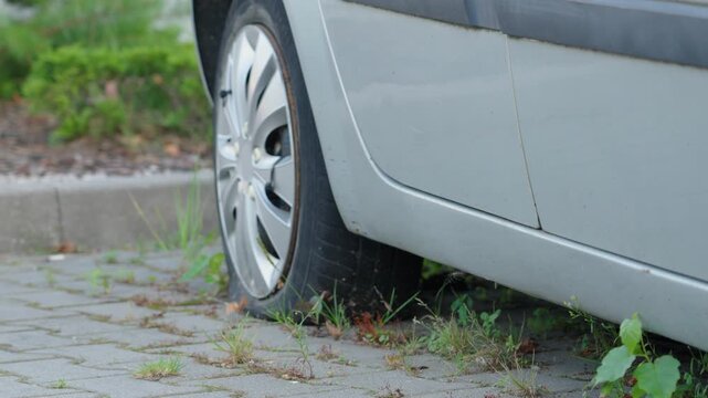 Flat tire in a quiet parking area on a sunny day