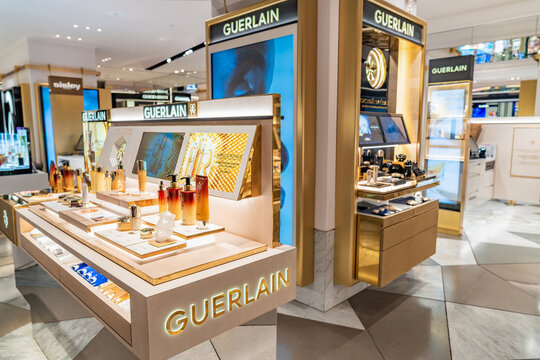 London, United Kingdom, 12 July 2023, Guerlain cosmetic counter inside a department store in London. Branded displays and product testers are arranged on illuminated shelves.