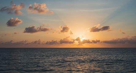 Dawn light illuminating tropical sea and sky in horizontal composition
