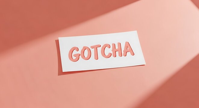 Paper sign with the word Gotcha written in playful handwriting