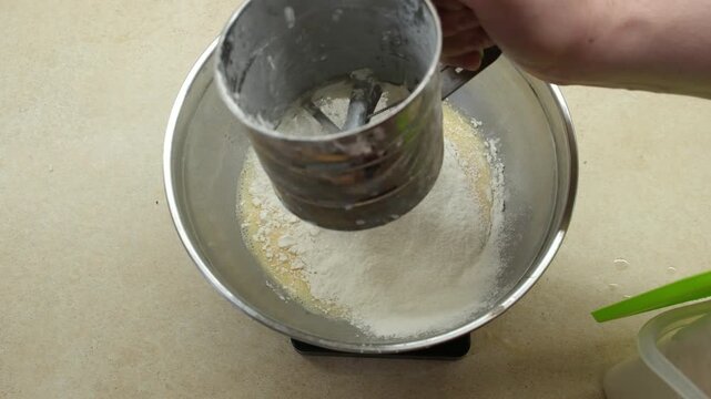 Sifting Flour into Mixing Bowl for Baking