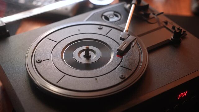 Close up view of a vintage turntable with a needle on a vinyl record, capturing the essence of analog music.