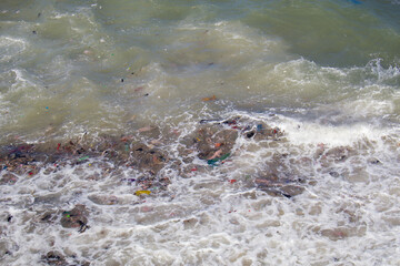 Ocean pollution with plastic waste in sea waves