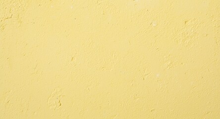Textured and vibrant pastel yellow stucco wall background illustrating playful serenity and copy space