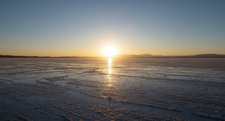 Quiet end of day light shimmering on salt flat ground