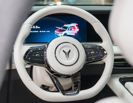 Voyah Free elegant E-SUV white interior, steering wheel, dashboard, setting buttons. Voyah is EV brand of Chinese State-owned automaker Dongfeng Motor Corporation.