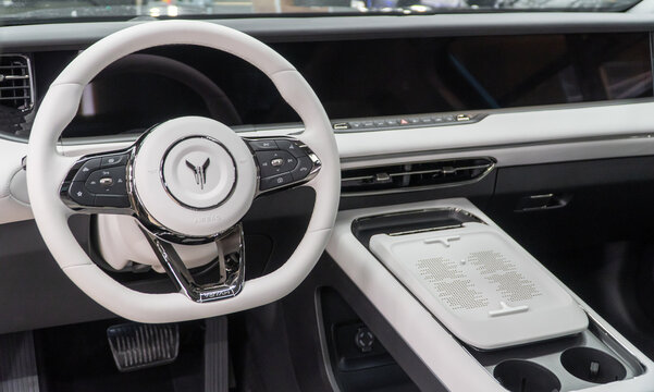 Voyah Free elegant E-SUV white interior, steering wheel, dashboard, setting buttons. Voyah is EV brand of Chinese State-owned automaker Dongfeng Motor Corporation.