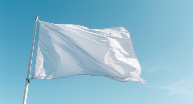 White flag captured up close waving against a clear blue sky with transparency effect