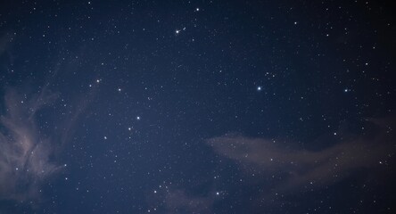 Obraz premium Star filled night sky close up with lightly drifting clouds