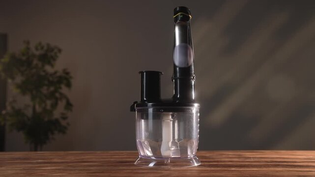 A sleek black kitchen blender with transparent bowl on a wooden surface. Perfect for modern culinary tasks.