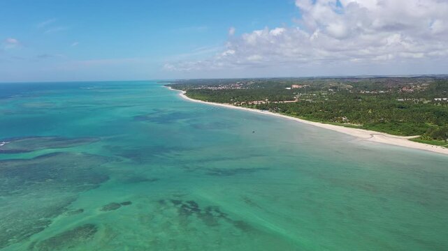 Fantiastic aerial view of calm beaches with natural swimming pools among the coral reefs of Milagres Route near Maceio City, Alagoas State, Brazil 