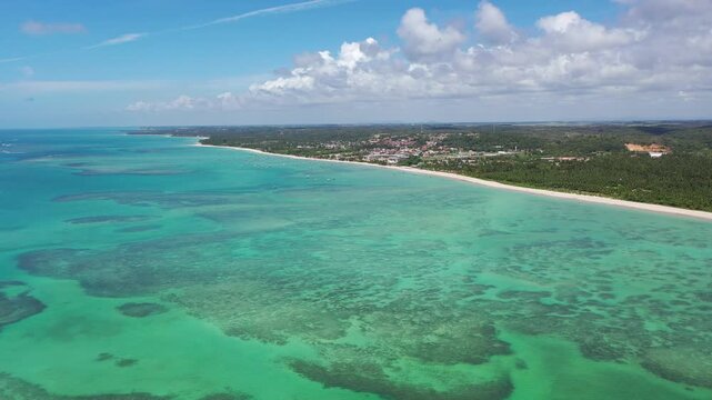 Fantiastic aerial view of calm beaches with natural swimming pools among the coral reefs of Milagres Route near Maceio City, Alagoas State, Brazil 