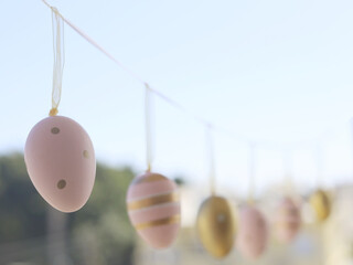 Pastel Easter Eggs Hanging Along Garden String