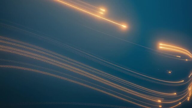 Golden light trails weaving through soft blue misty background