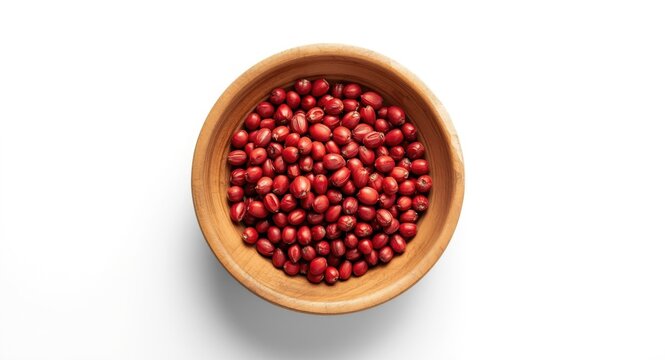 Natural wooden bowl with red annatto seeds from Bixa Orellana tree on plain white