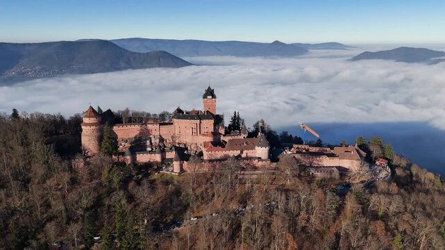 Ch&acirc;teau du Haut-Koenigsbourg medieval castle rising above a cloud inversion in Vosges mountains