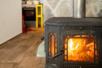 Cast iron furnace inside a cozy mountain lodge.