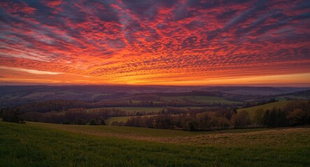 Sunset featuring crimson sky and peaceful countryside
