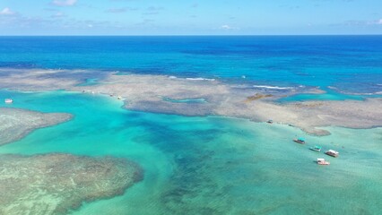 Wonderful view of white sand beach with turquoise waters and coral reefs in Milagres route near Maceio city, Alagoas State, Brazil  © MARCIA COBAR