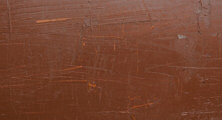 Pressed wood surface with brown paint coating and gentle daylight texture background