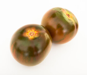 Fototapeta premium ripe black tomatoes on a white background